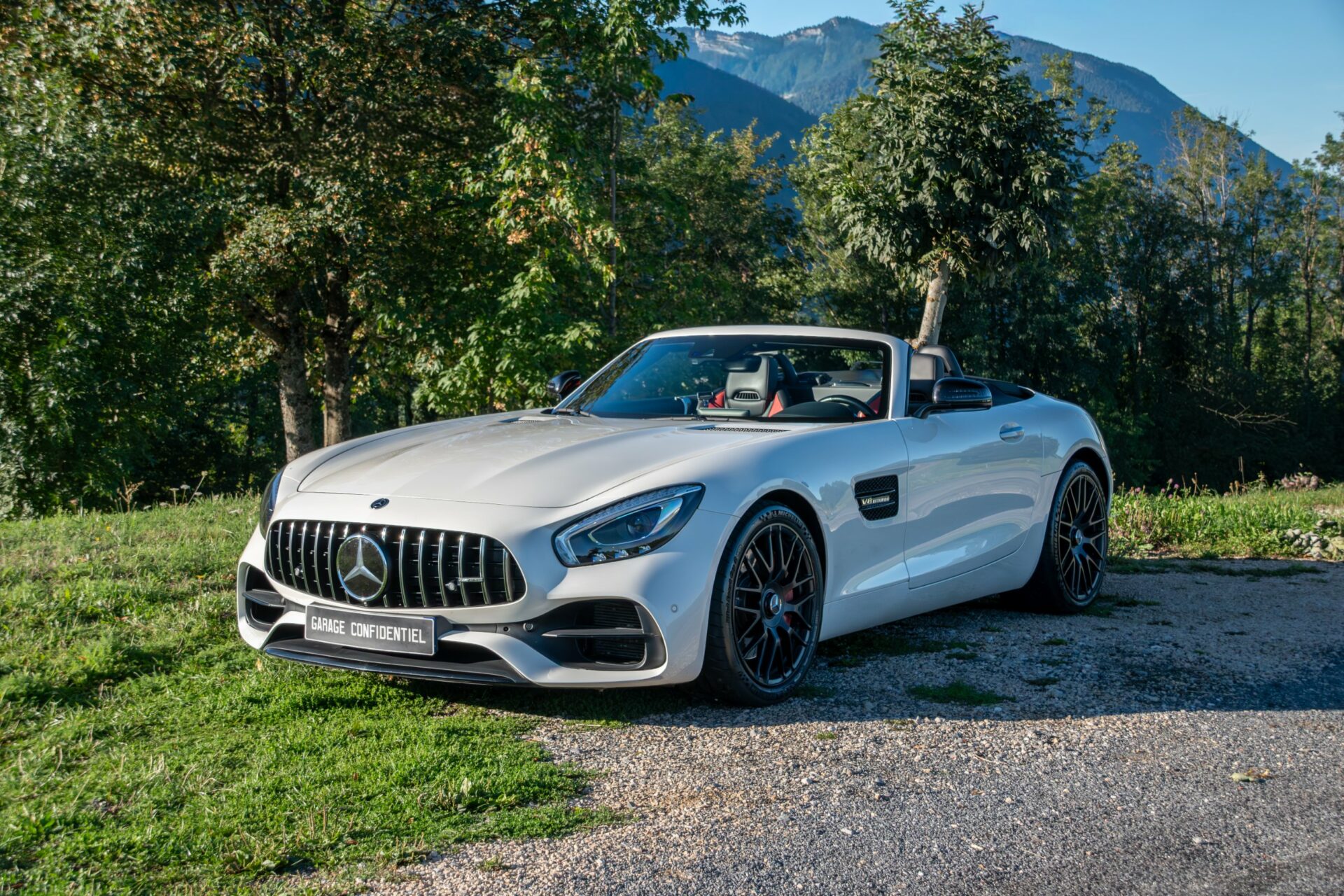 Mercedes-AMG GT Roadster blanc devant les montagnes – Garage Confidentiel